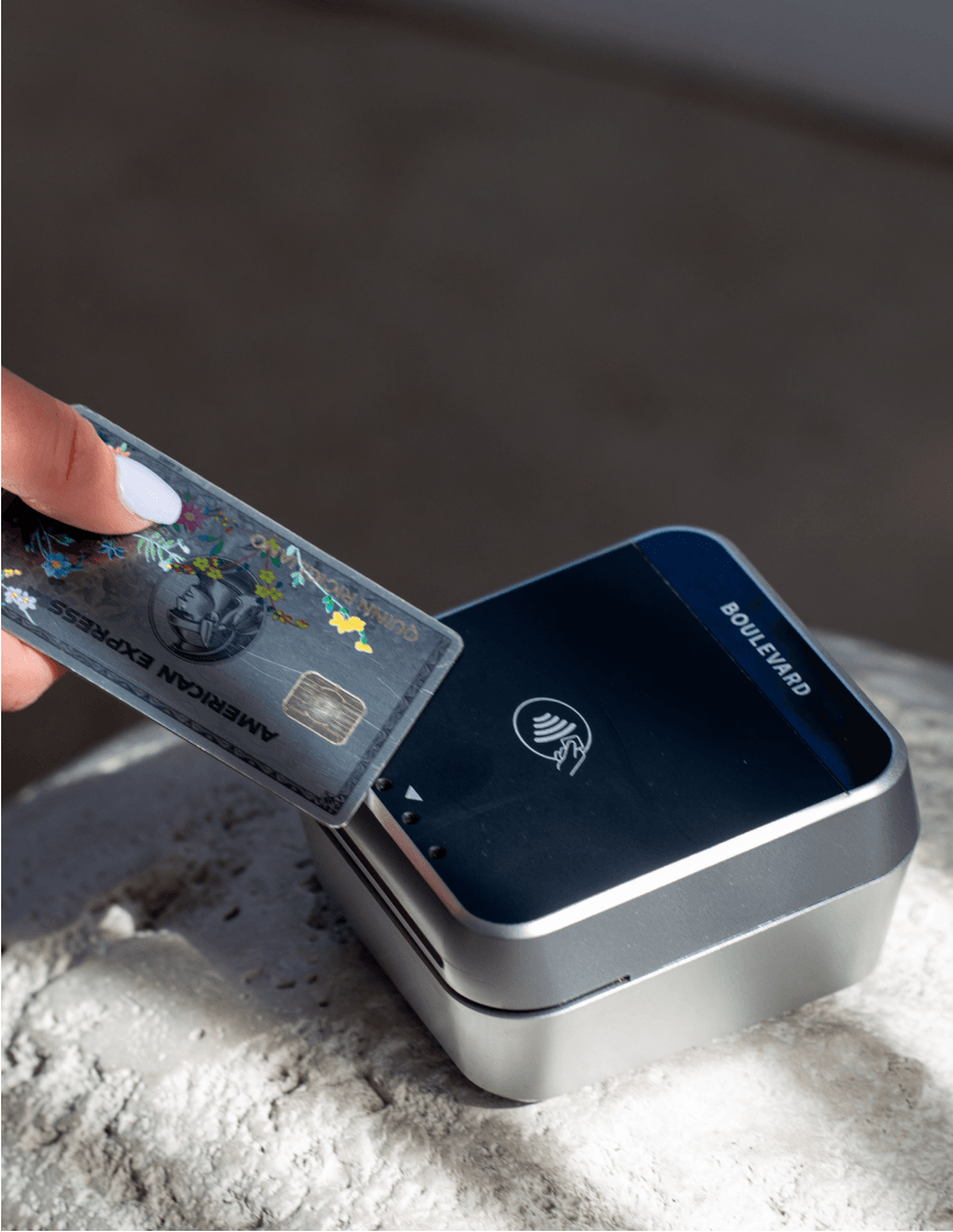 A client tapping a card on a Boulevard card reader