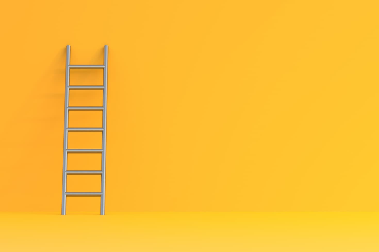 A stainless steel ladder is propped up against a yellow wall.